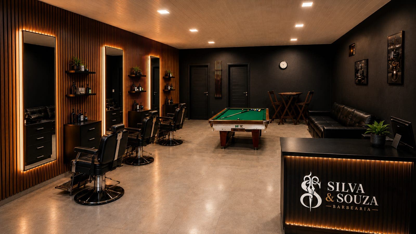 Interior da barbearia com espelhos iluminados, cadeiras pretas e mesa de sinuca